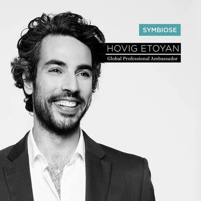 Hovig Etoyan, Global Professional Ambassador for Symbiose, smiling in a professional suit with dark hair.