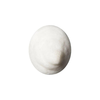 Foamy white facial cleanser in circular shape for skincare routine.