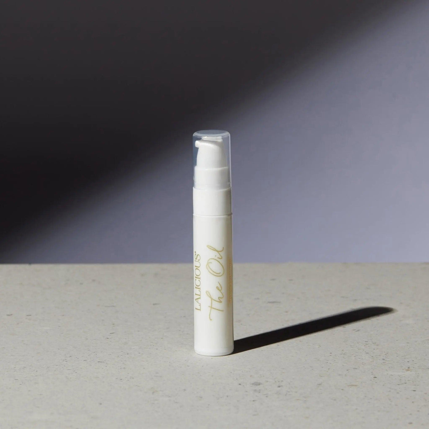 Luxurious The Oil bottle on a textured surface, showcasing its elegant packaging and modern design.