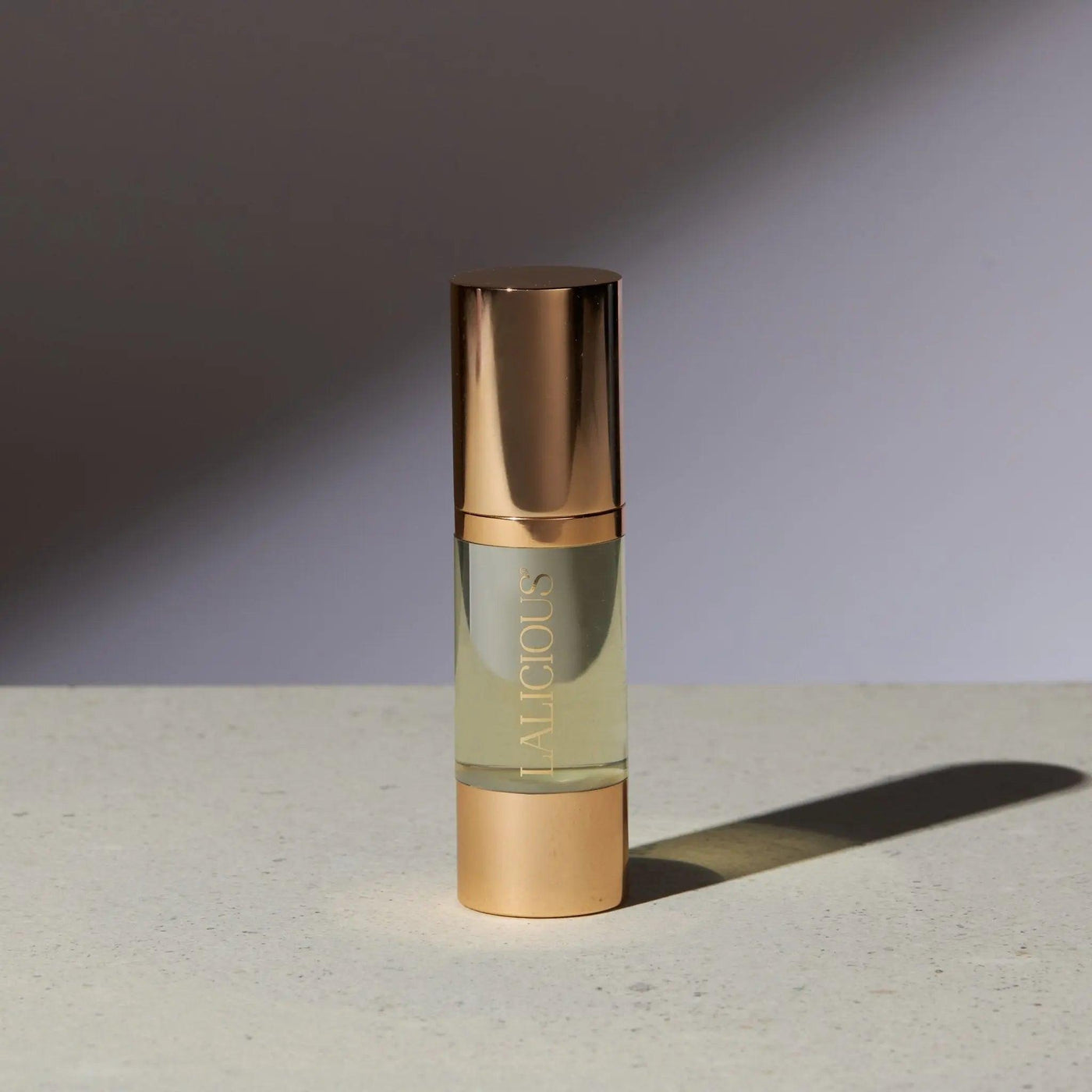 Elegant bottle of The Oil from Signature Collection, featuring luxurious gold accents and a light golden formula.