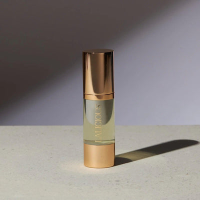 Elegant bottle of The Oil from Signature Collection, featuring luxurious gold accents and a light golden formula.