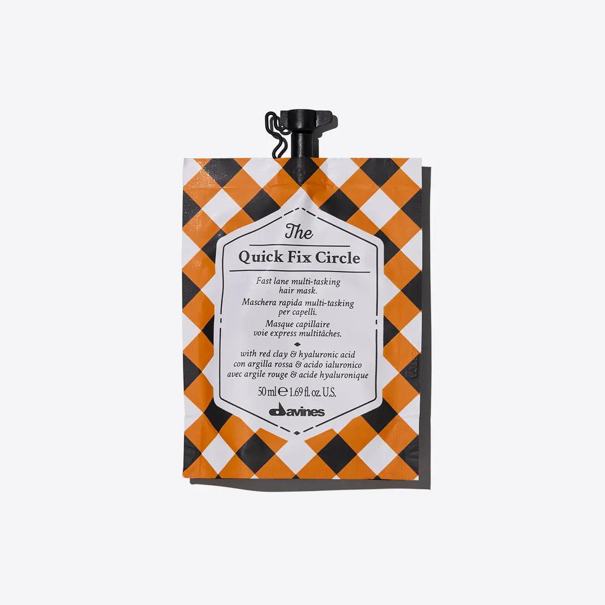 Davines The Quick Fix Circle multi-tasking hair mask pouch with a checkered design, ideal for quick hydration and detangling.