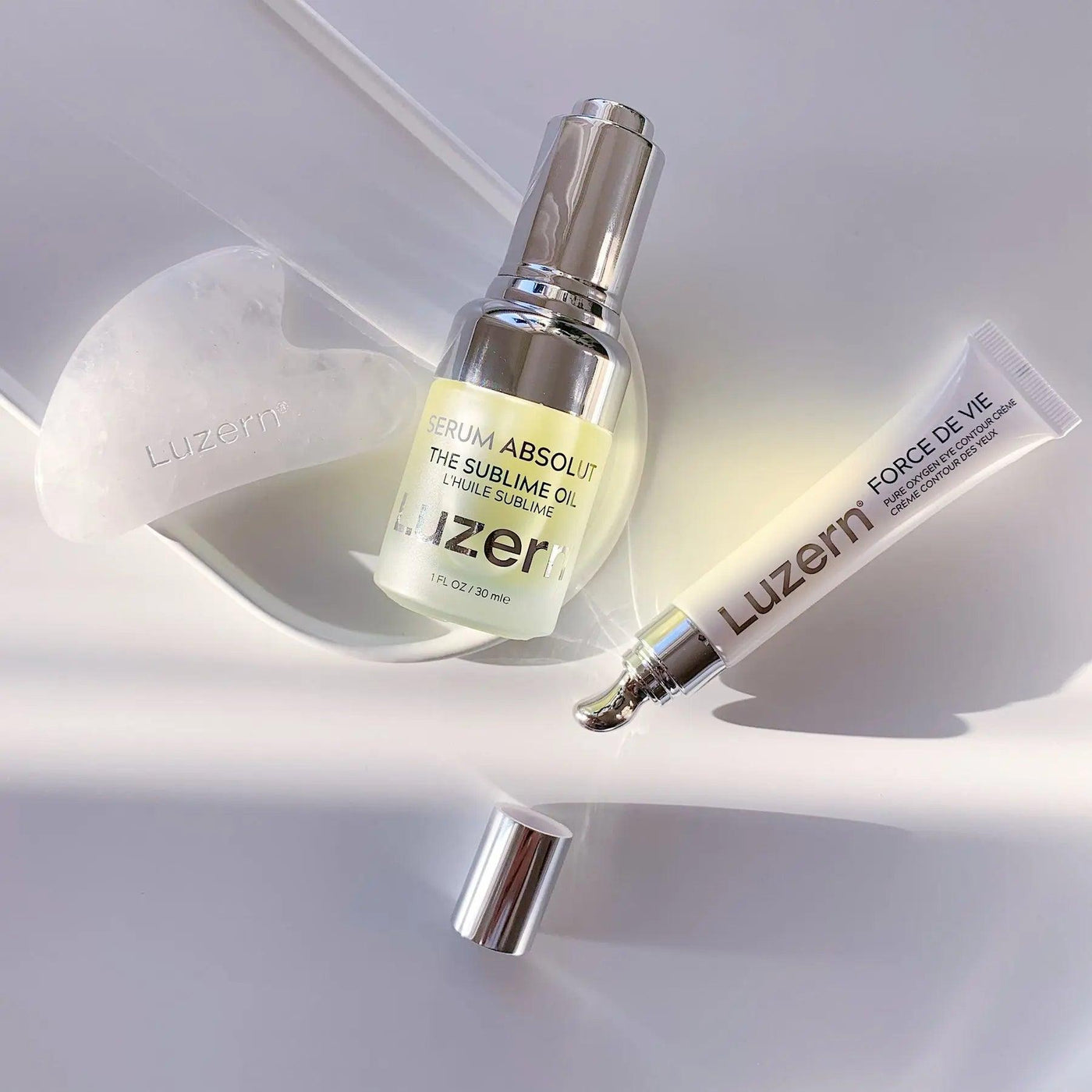 Luxurious Luzern skin care products including Serum Absolut and Force De Vie displayed on a white surface.