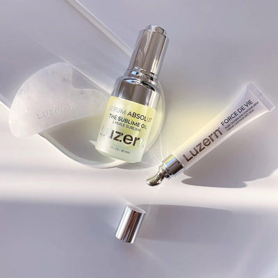 Luxurious Luzern skin care products including Serum Absolut and Force De Vie displayed on a white surface.