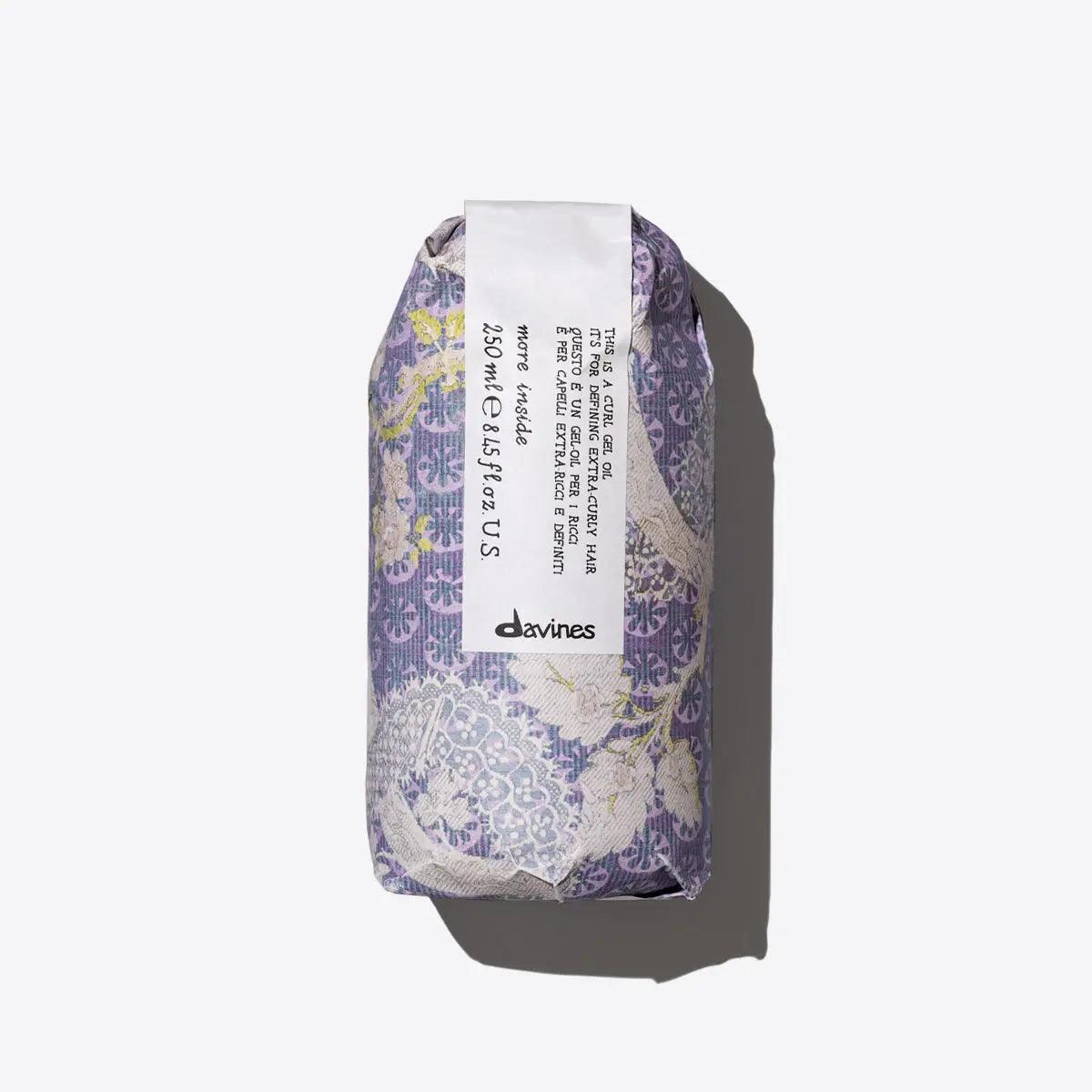 Davines curl gel oil packaging featuring elegant floral design and informative label for hydrated, defined curls.