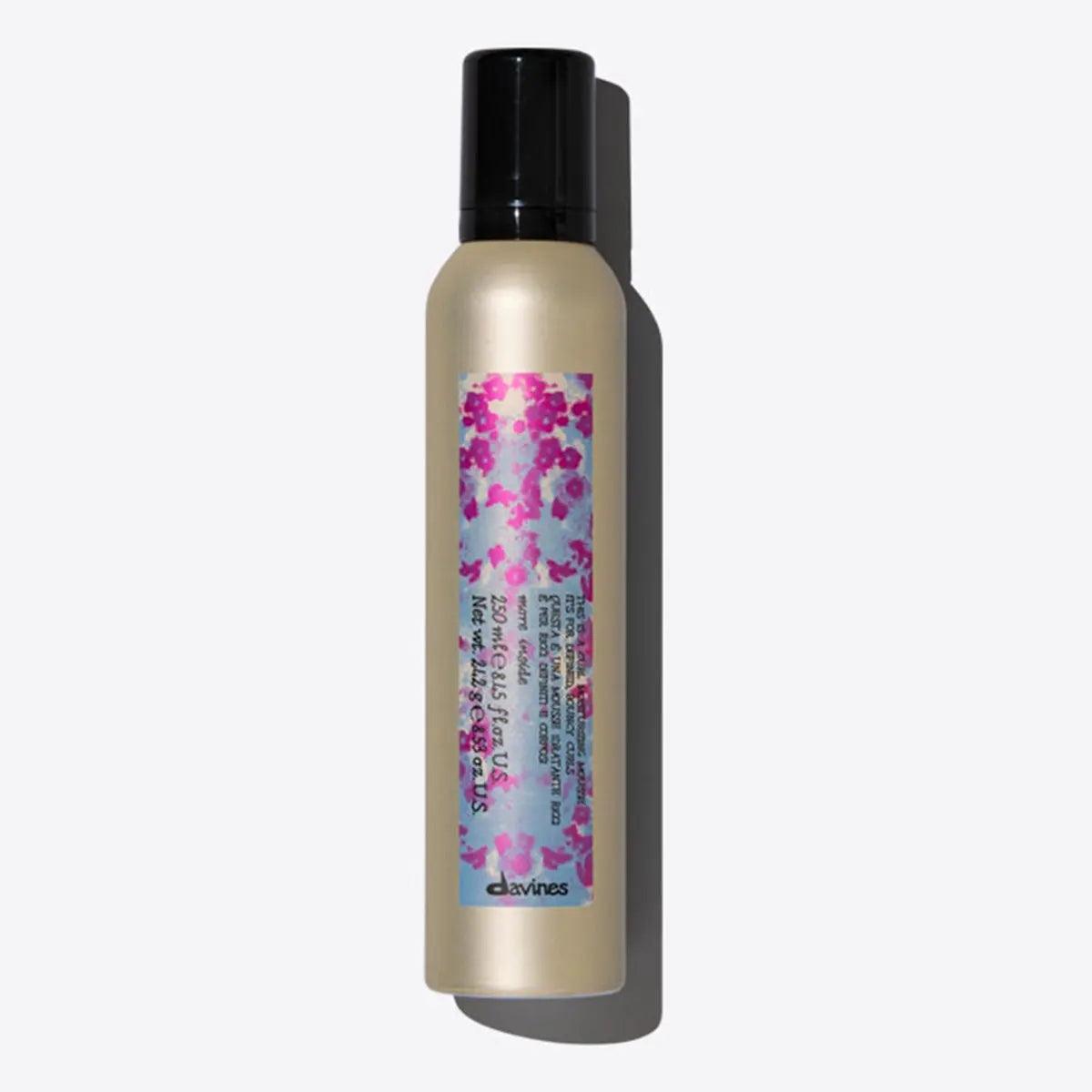 Davines curl moisturizing mousse bottle for hydrating and defining curls, maintaining bounce and structure.
