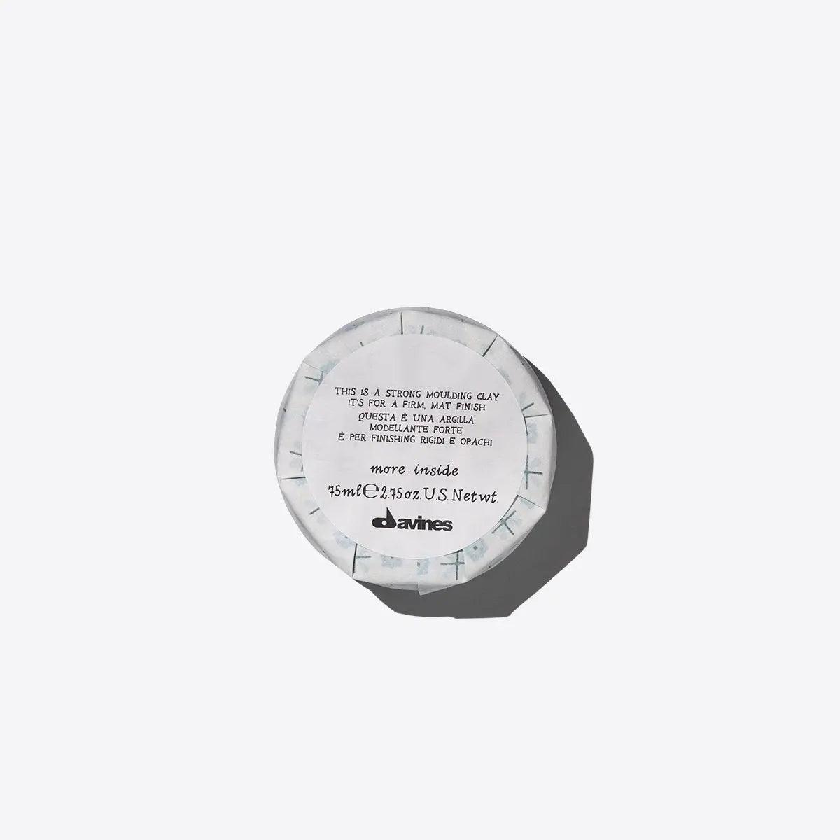 Davines strong molding clay hair product in white packaging for styling and hold