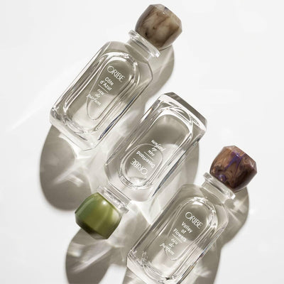 Luxurious Oribe perfumes with elegant marble caps on display