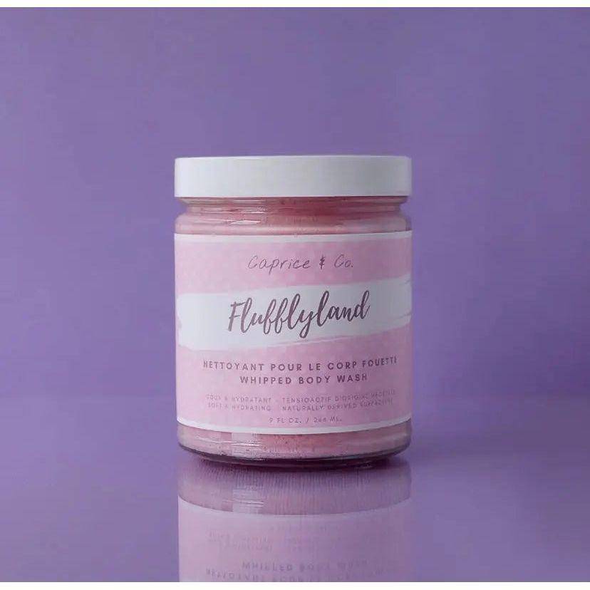 Flufflyland whipped body wash in pink jar by Caprice & Co. on a purple background, perfect for moisturizing skin.