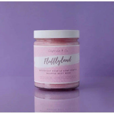 Flufflyland whipped body wash in pink jar by Caprice & Co. on a purple background, perfect for moisturizing skin.